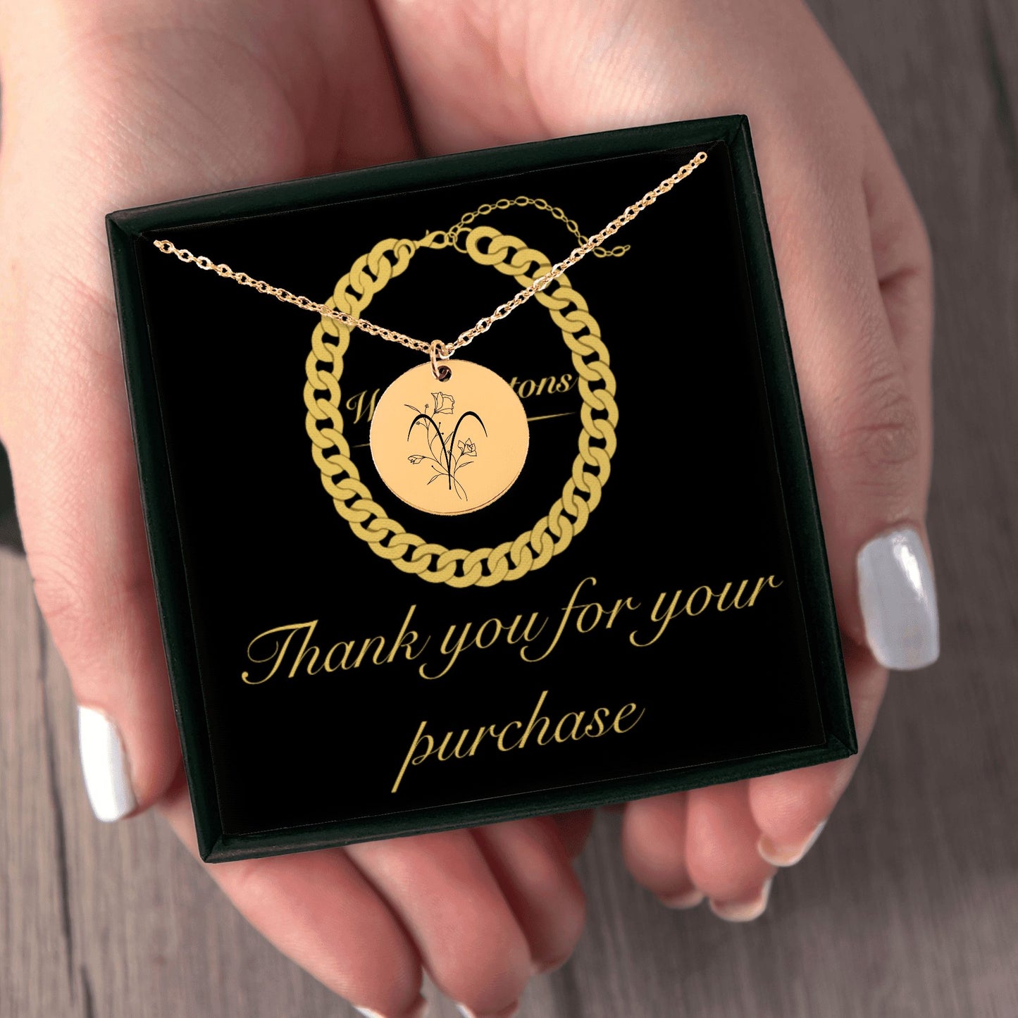 Woman holding zodiac sign necklace